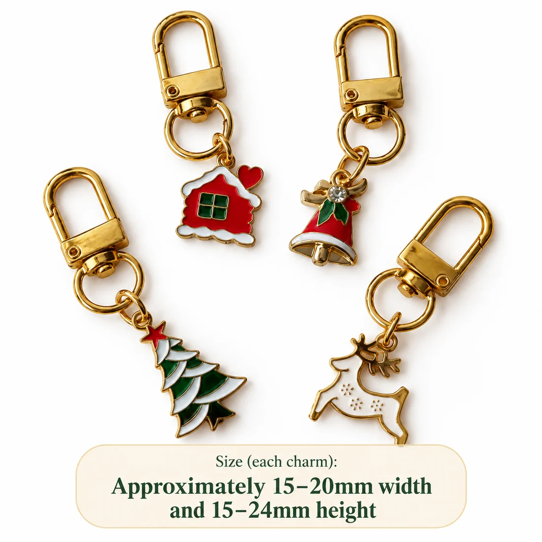 Four enamel Christmas charms - a house, a bell, a tree and a reindeer - shown together with a note giving each charm as approximately 15 to 20 mm wide and 15 to 24 mm high.
